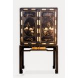 An 18th century Chinoiserie black lacquered chest on stand, the two upper doors decorated with