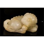 A white jade temple lion, carved with fine detail.