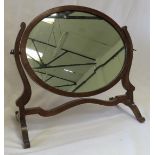 An Edwardian mahogany oval toilet mirror.