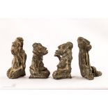 A group of four African bronze monkey figures.