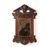 A 19th century Italian carved mirror, depicting ch