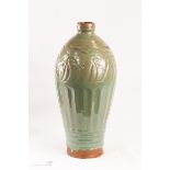 A terracotta celadon glazed vase.