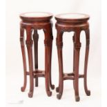 A pair of Chinese hardwood stands with dream marbl