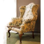 A 17th century style walnut wingback armchair.