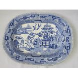 A large oval dish with early Willow pattern.