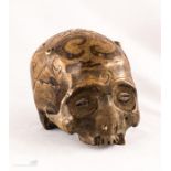 A Dayak human trophy scull, Borneo, carved with de