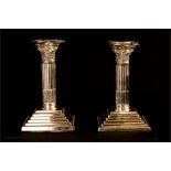 A pair of silver candlesticks in the form of Corin
