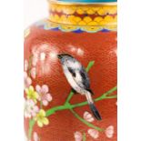 A Cloisonne vase, depicting a bird.