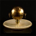 A spherical gilt brass inkwell raised on an agate