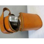 A leather hip flask holder containing two chrome t