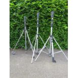 Three photography tripods, including two by Manfrotto.