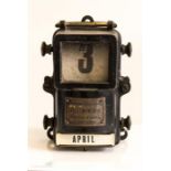 An antique Electricity House Meter metal cased perpetual calendar in the shape of an electricity