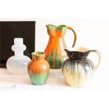 An opaque glass vase, Arcadia pattern jug and vase, blue and black streaked jug.