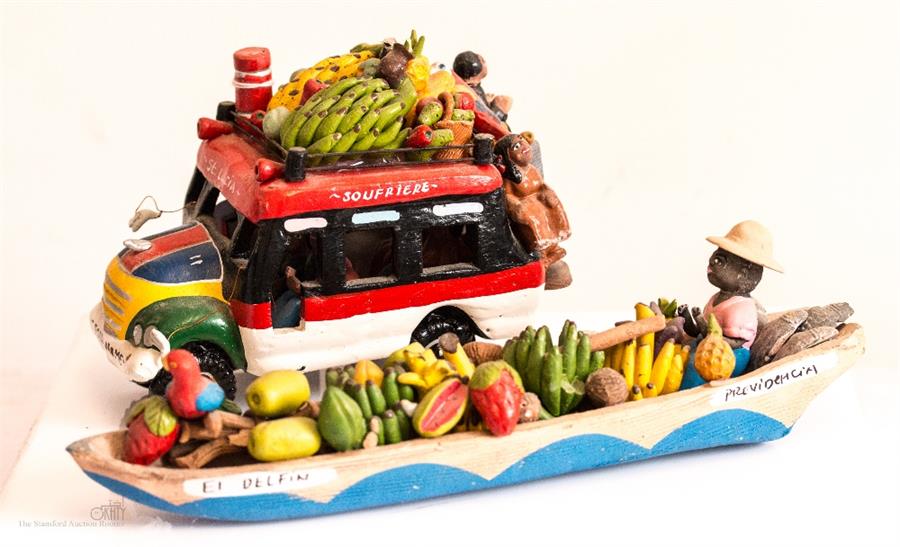 St Lucia model of a tour bus and Fresh Fruit seller in a canoe with a parrot pilot.