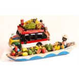 St Lucia model of a tour bus and Fresh Fruit seller in a canoe with a parrot pilot.