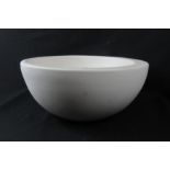 A white modernist powder finish ceramic bowl.