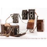 Four Rolleicord twin lens reflex vintage cameras with cases with cased Rolleicord accessories.
