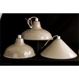 Three industrial design grey enamel pendant light fittings, two of similar profile and one