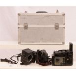 Three professional camera bodies in a silver metal case to include FUJI GX 680, Canon EOS- 1,