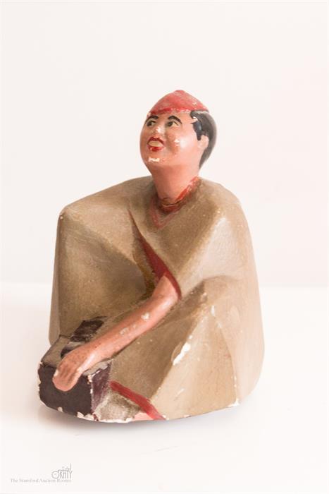 A money box in the form of seated Arab shoe-shine boy.