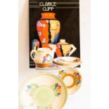 A group of Clarice Cliff; tea pot, saucers and a plate, together with a Clarice Cliff reference