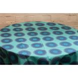 Almedahls Circular orange pattern tablecloth and bold blue pattern rectangular table cloth.