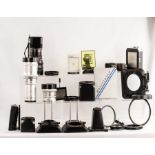 A large quantity of used Hasselblad photography pieces of equipment in a solid black heavy duty