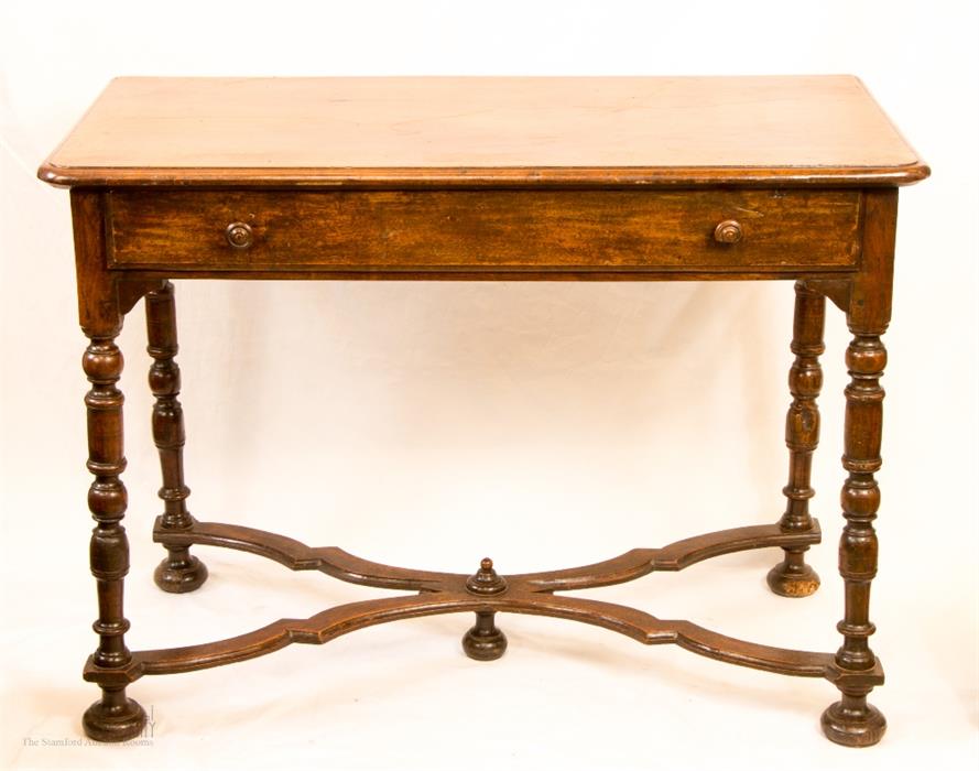 An early 19th century table with wavy stretcher and single drawer.