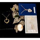 A quantity of silver necklaces in the form of hearts, crosses, and brooches.