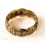 A yellow metal ring with paste stones.