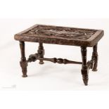 An Indian hardwood stool with a carved top.