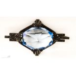 An Art Deco style marcasite and blue glass brooch.