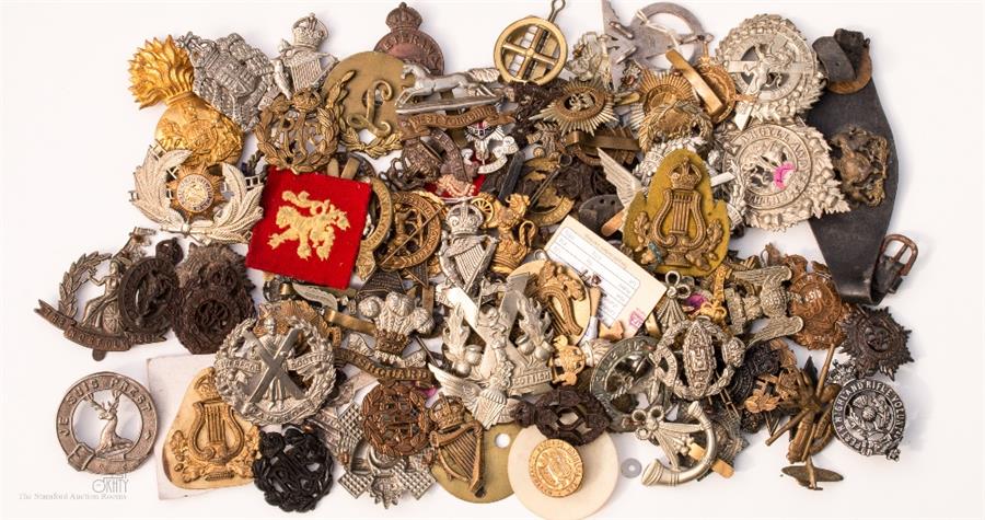 A group of military cap badges.