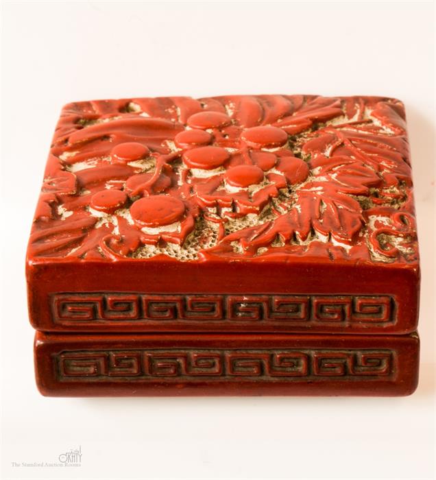 A square cinnabar style trinket box.