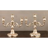 A pair of continental silver candlesticks,with three branches, 28cm high.