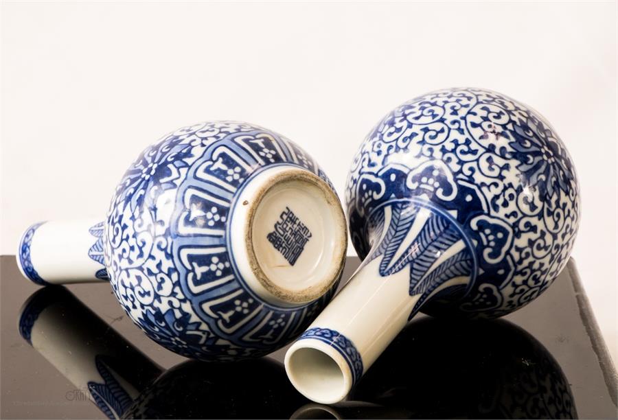 A pair of blue and white bottle vases with seal mark underside. - Image 4 of 4