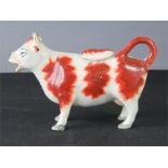 A 19th century Staffordshire cow creamer, with lid.