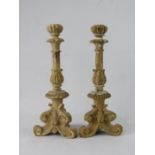 A pair of limewashed oak carved candlesticks.