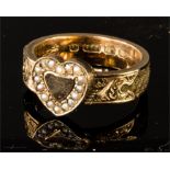 A 9ct gold mourning ring, with central heart set with seed pearls, and the band inset with woven