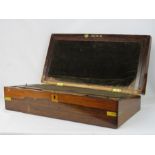 A 19th century rosewood and brass inlaid work box with leather interior slope and inkwells.