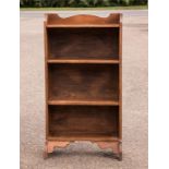 A small oak bookshelf with four shelves.