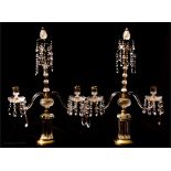 A pair of Russian Baccarat style cut glass and gilt brass candleabra 69½ high, 45cm wide.