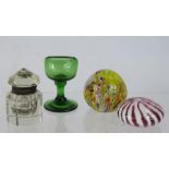 A Victorian cut glass inkwell, and two glass paperweights, with an early green glass eye bath.