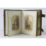 A Victorian photograph album containing black and white portraits.