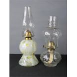 Two Victorian glass and brass oil lamps, one with mottled glass.