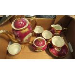 A miniature tea service, tea pot, milk jug, sugar bowl and four cups and saucers.