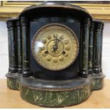 An ebonised mantle clock, with green faux marble columns adorning the front.