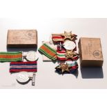 Two boxed WWII medal groups.