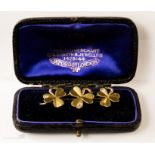 A yellow metal and diamond brooch, three clover leaves set with small chip diamonds, in original