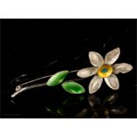 A sterling silver and enamelled flower brooch.